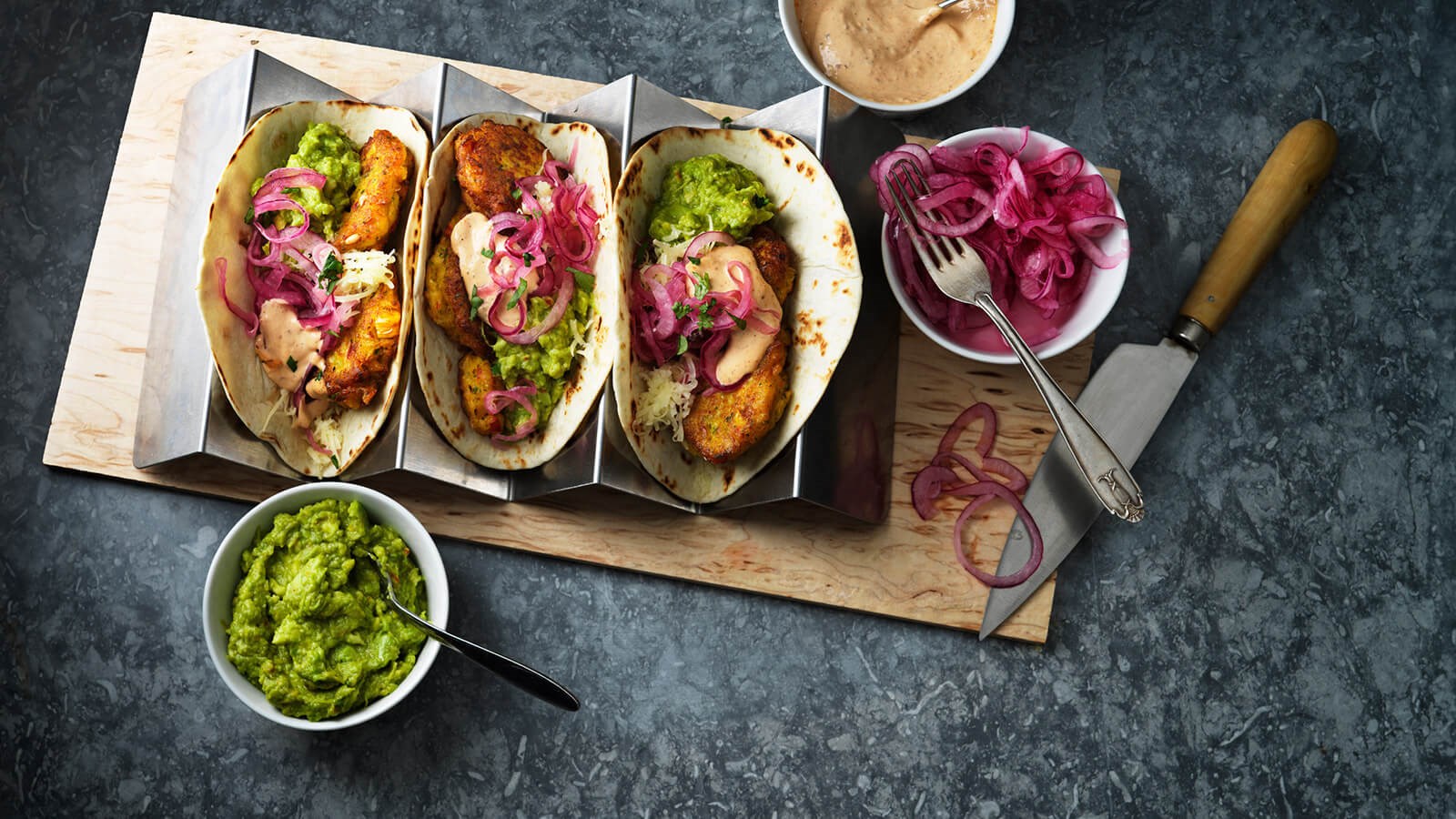 Three tacos with corn fritters and guacamole