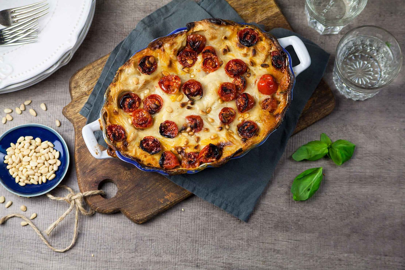 Vegan lasagne with cherry tomatoes in an ovenproof dish
