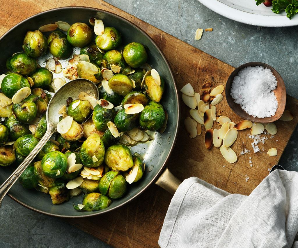 A pan with brussels sprouts and almonds