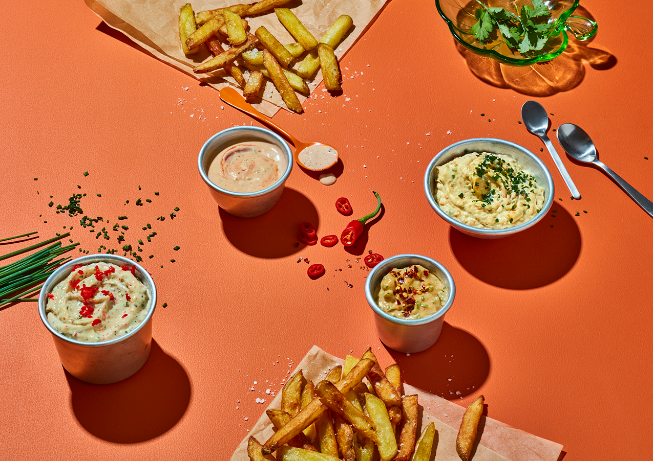 Dressing och såser serveraAmerikkalainen Hampurilaiskastikede på bord med pommes