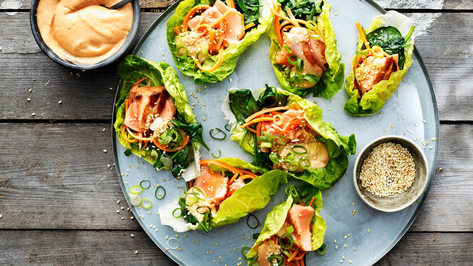 Plate with grilled Asians salmon wrapped in salad