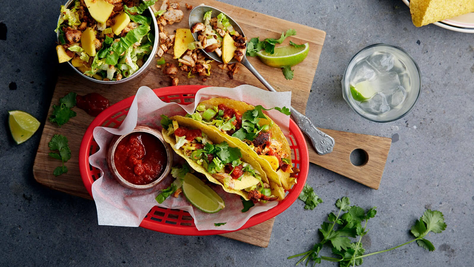 Twee taco's met kip geserveerd op een rode plastic bord