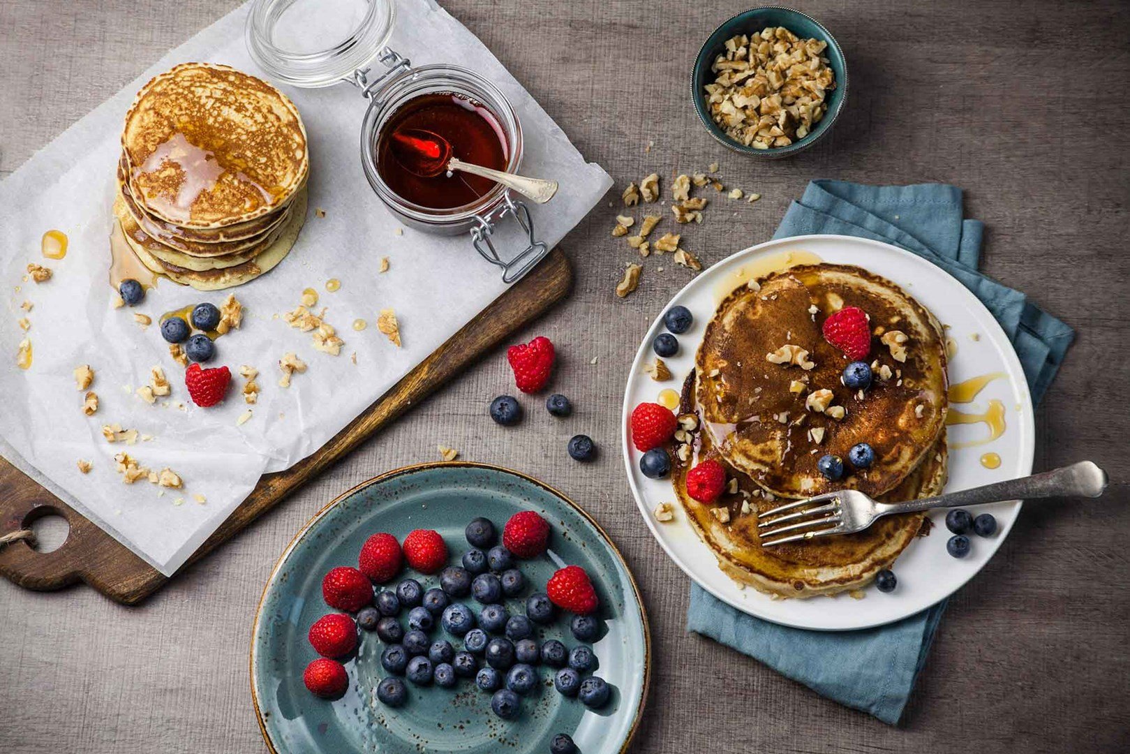 Vegan pancakes with raspberries, blueberries, maple syrup and pecans