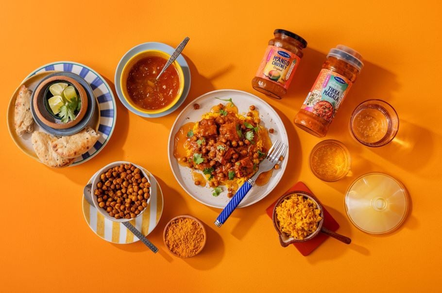 Tikka masala ar turku zirņiem un naan maizi uz galda