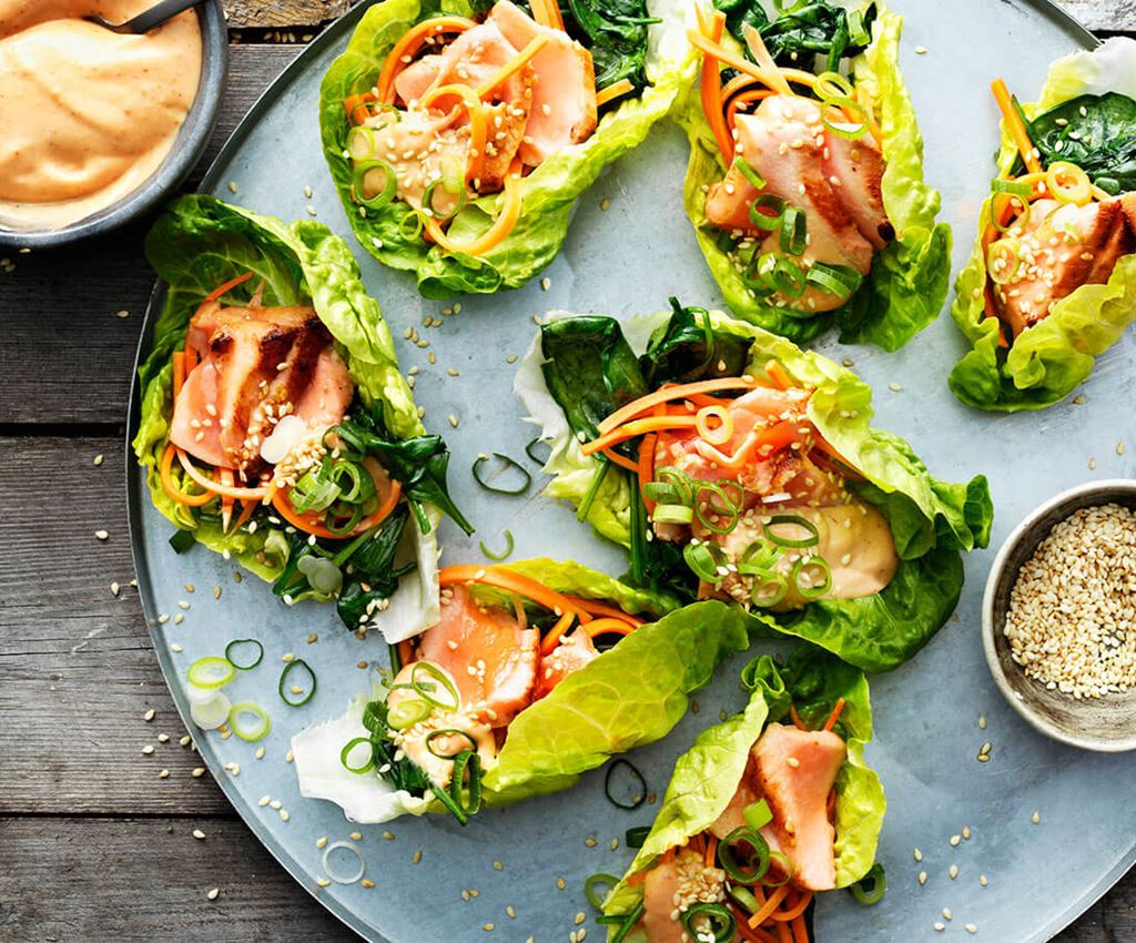 Plate with grilled Asians salmon wrapped in salad