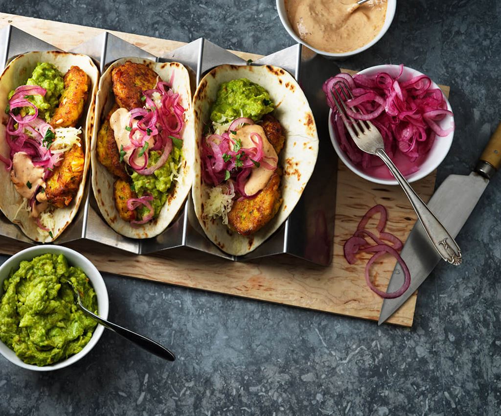 Tre tacos med cornfritters och guacamole