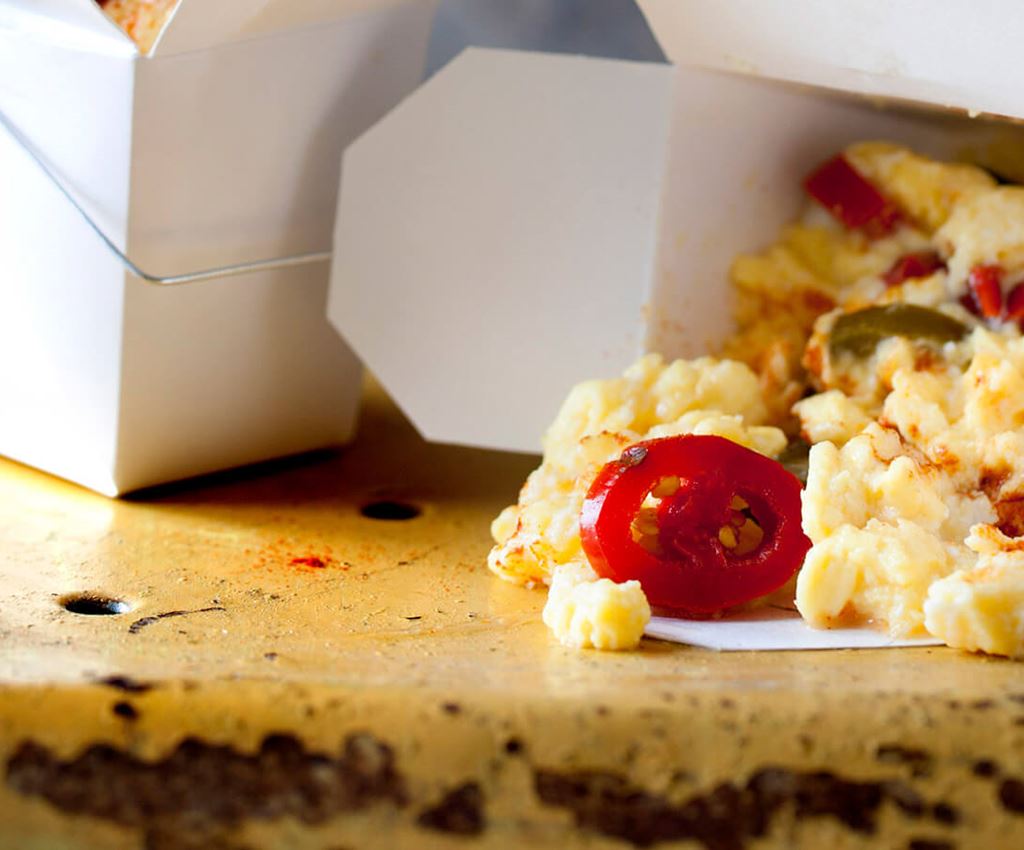 Scrambled eggs with jalapeño in take away boxes