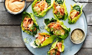 Plate with grilled Asians salmon wrapped in salad