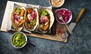 Three tacos with corn fritters and guacamole